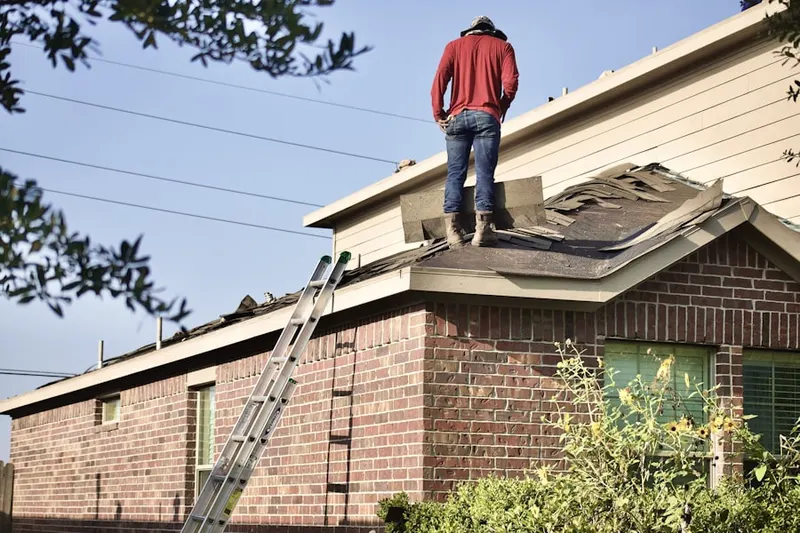Professional roofer working on a residential roof in Curtis Bay